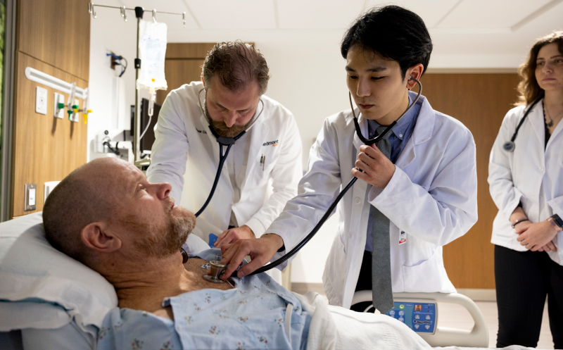 Patient Russell Cobb has his pulse listened to by cardiologist Dr. Matt Crim as he works with second year medical student Christopher Rhee as fellow second year student Erika deAndrade watches on while making rounds at Piedmont Athens Regional Medical Center.